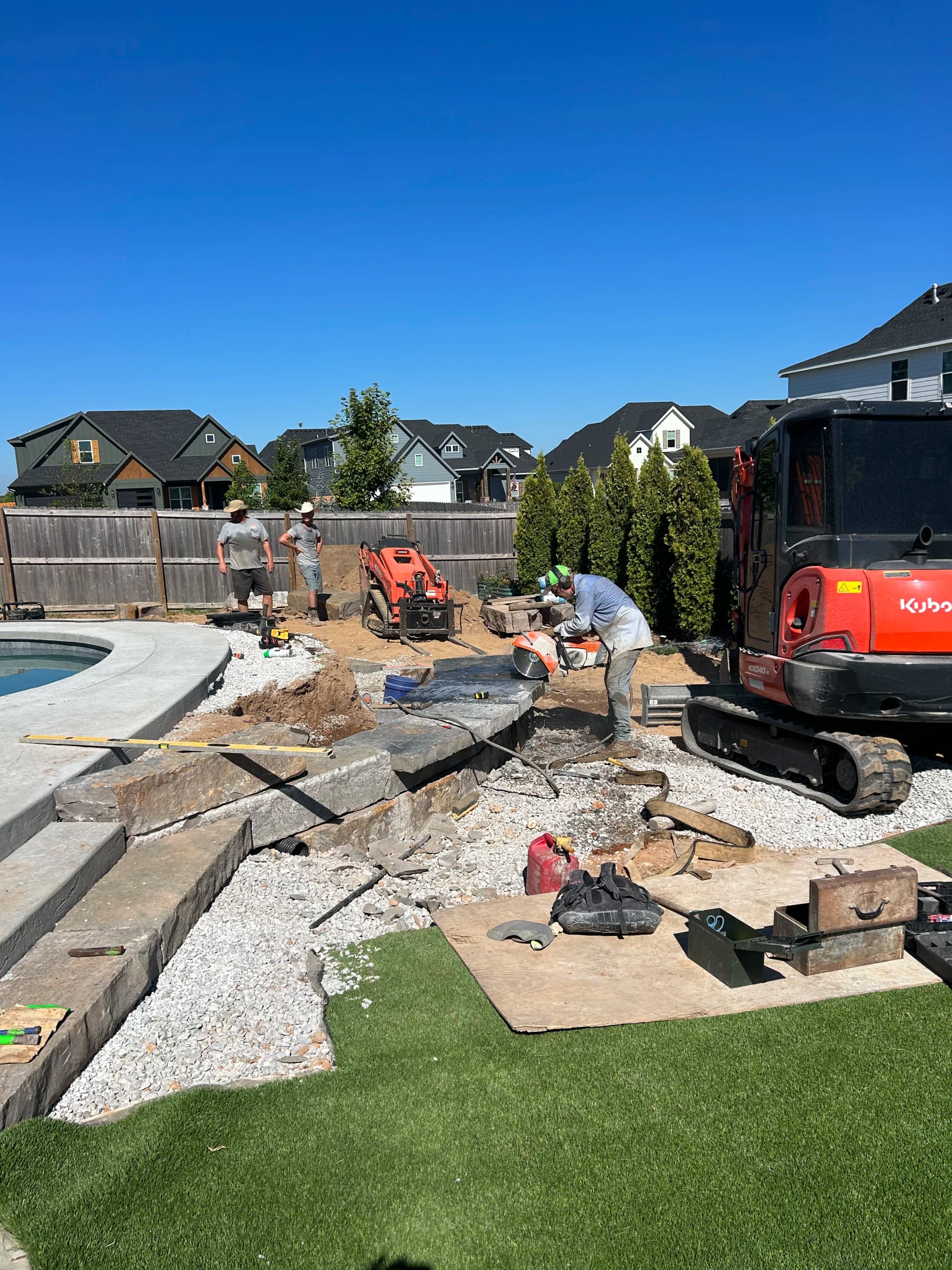 Backyard Hardscape Build with Seating Wall and Water Feature in Bentonville image