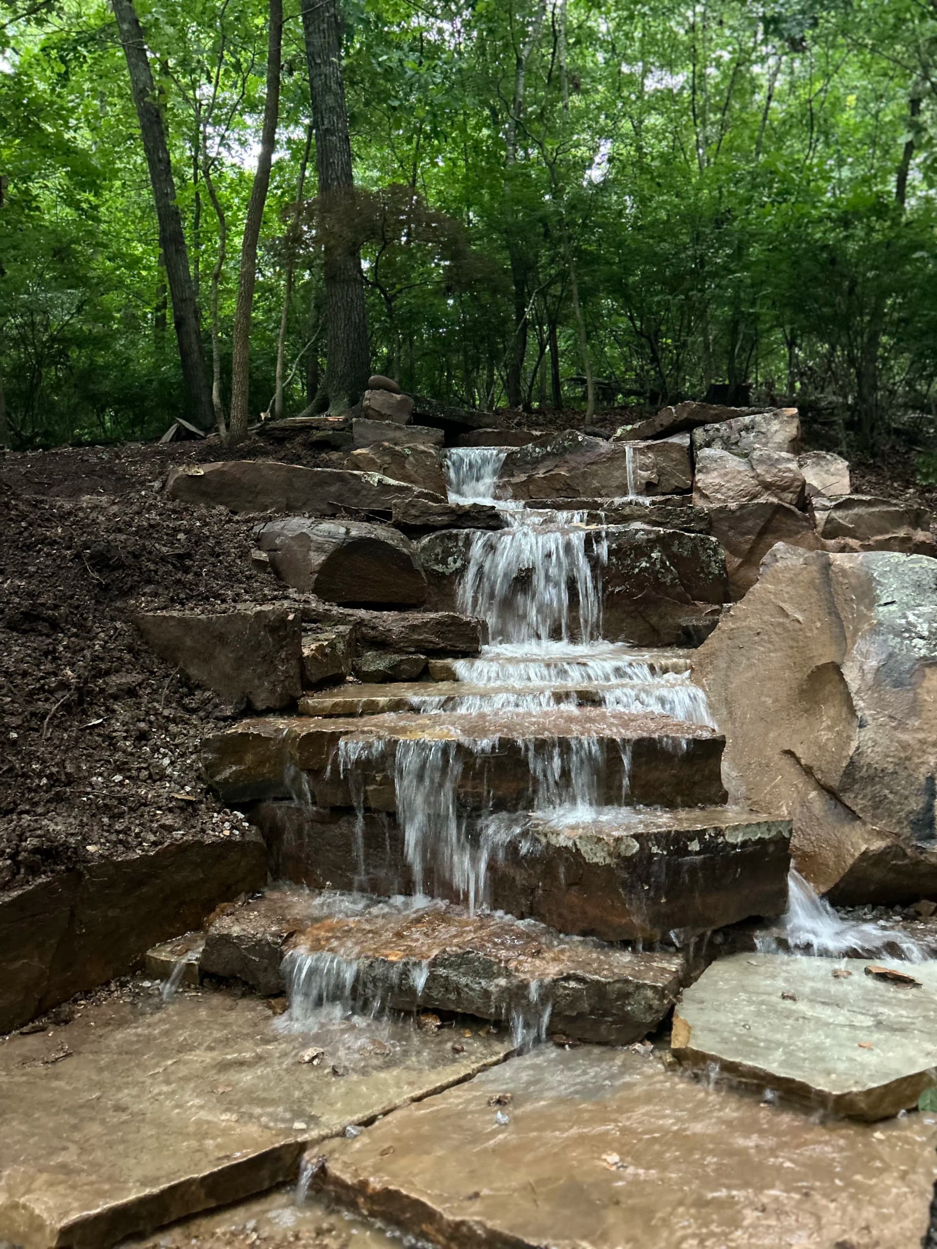 Natural Stone Waterfall Built Into a Bella Vista Hillside image